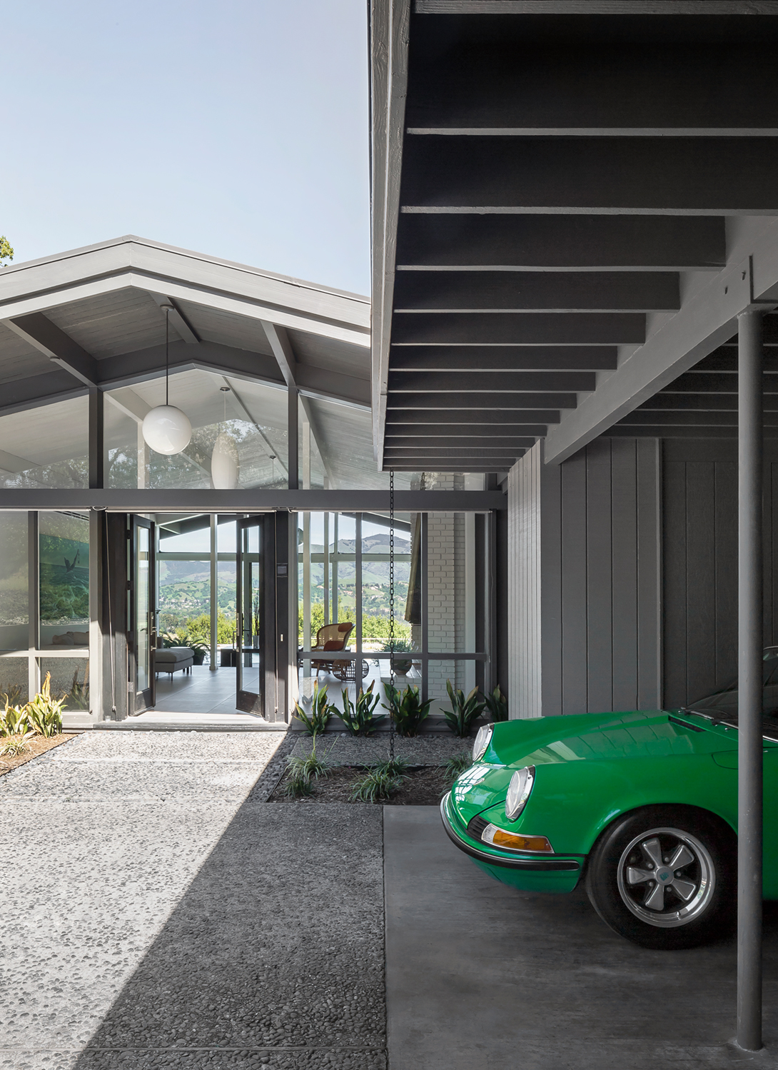 The central entry court and original carport were refreshed with paint.