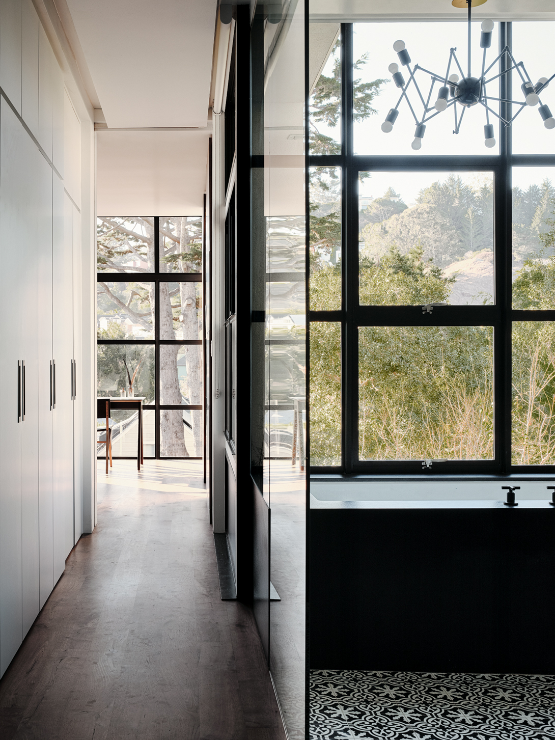 The greenery of the landscape fills the steel-framed glass walls of the master bedroom 