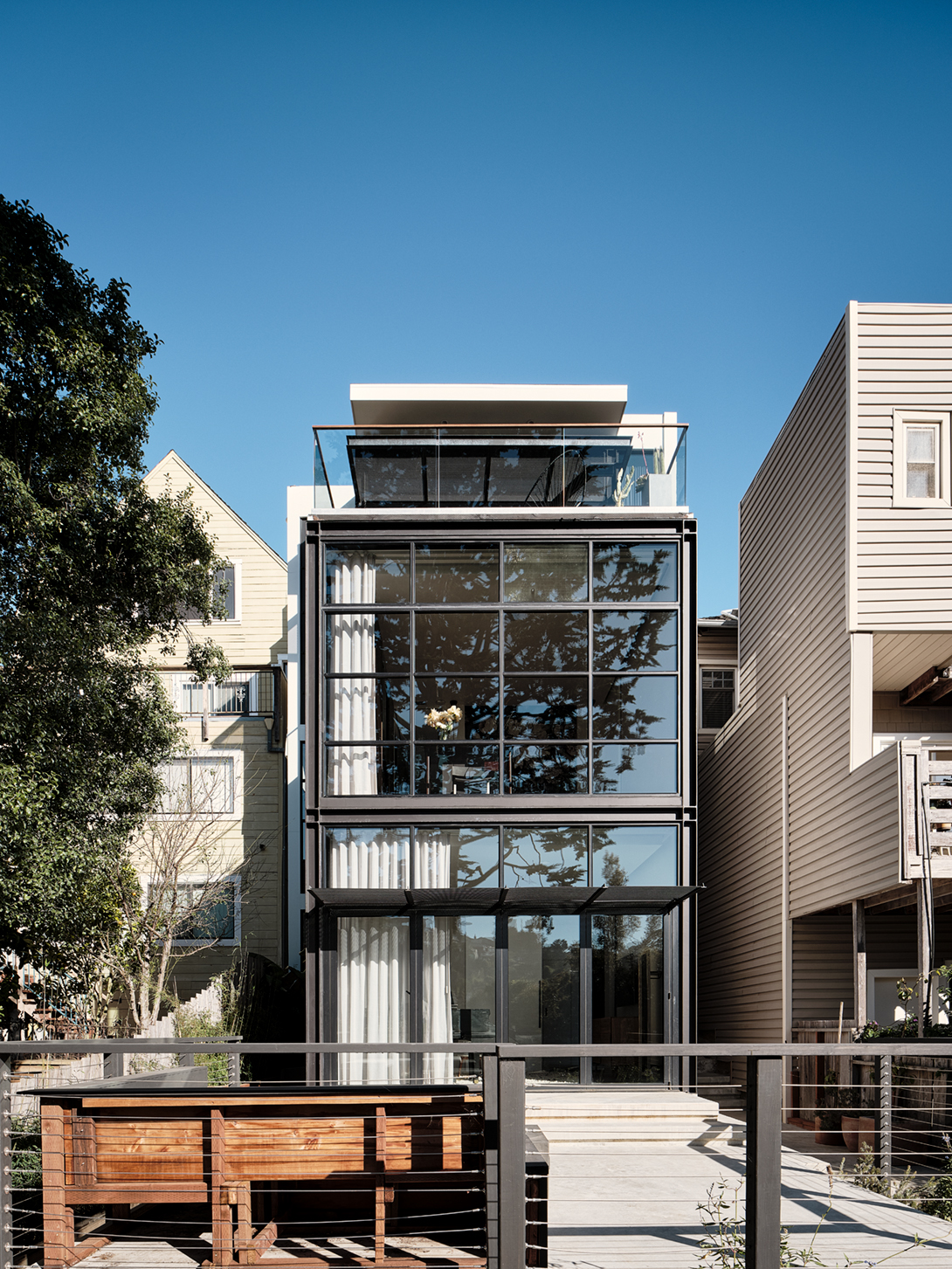 The glass-and-steel rear facade is like an aperture for the house