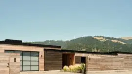 Beyond the understated façade of this home lies stunning views of the Bolinas Lagoon and coastal range.