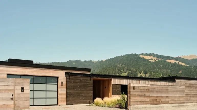 Beyond the understated façade of this home lies stunning views of the Bolinas Lagoon and coastal range.