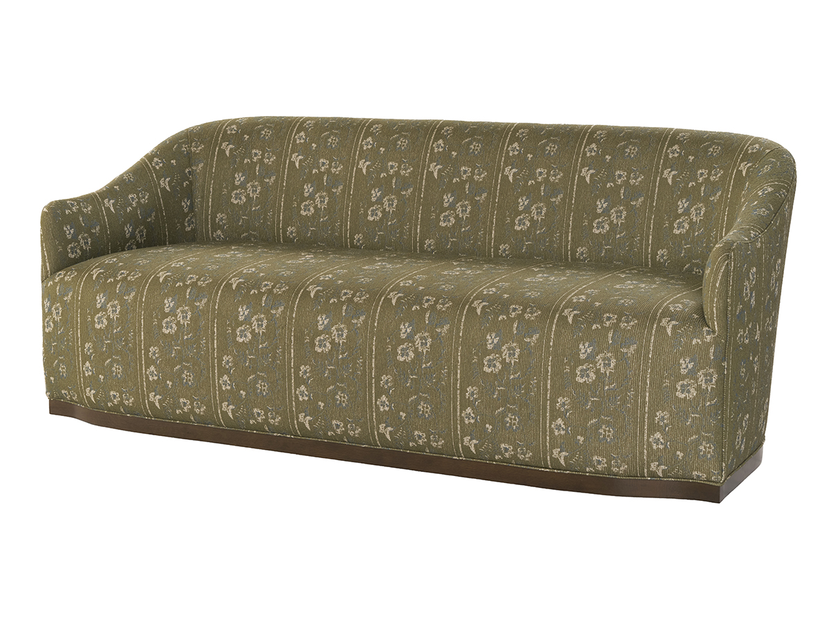A green sofa featuring a colorful floral pattern, adding a lively touch to the room's decor.