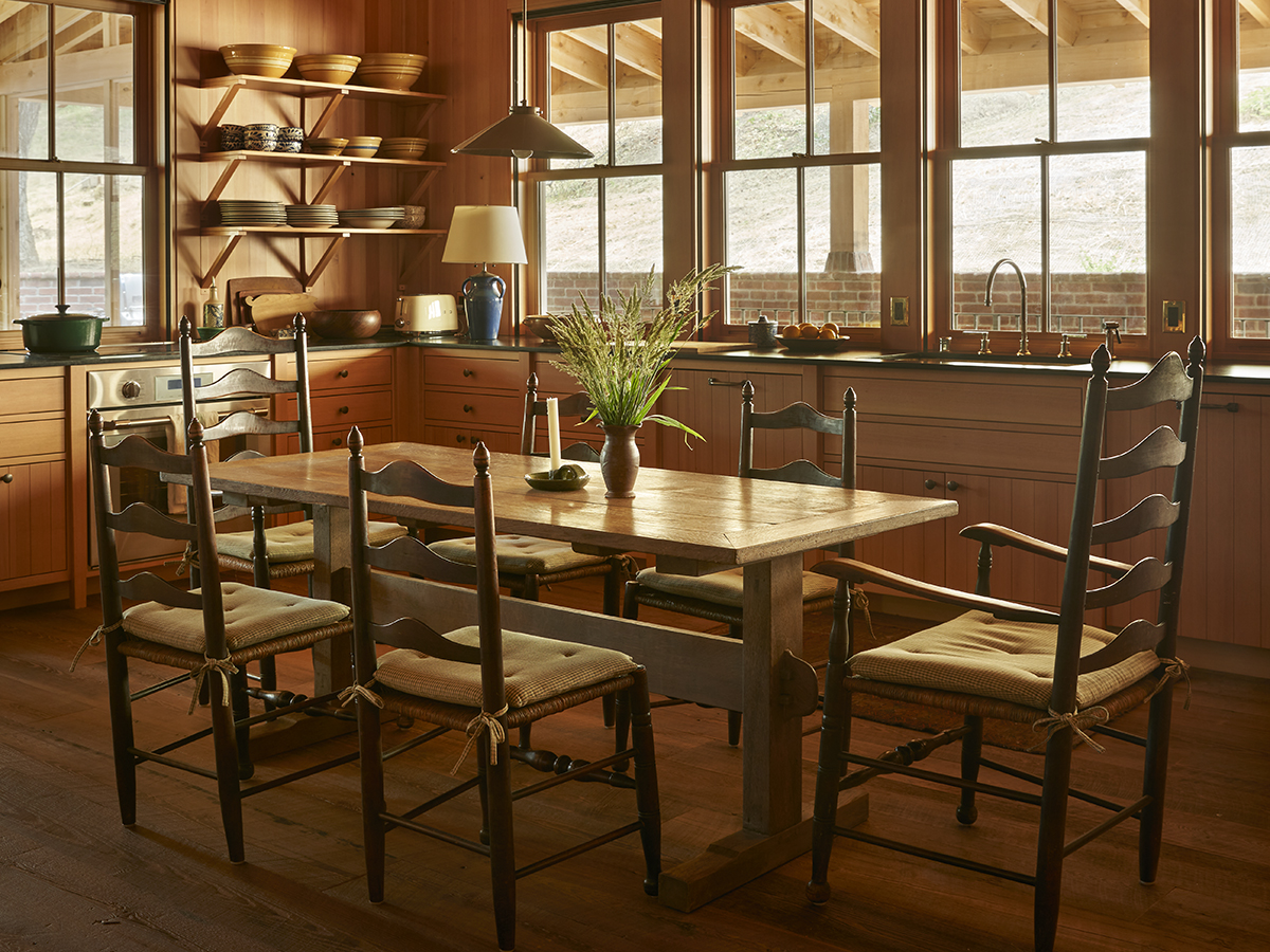 A cozy kitchen featuring a round table surrounded by four chairs.