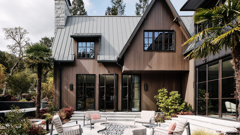 A contemporary house with a large patio area and a fire pit, perfect for entertaining and enjoying outdoor evenings.