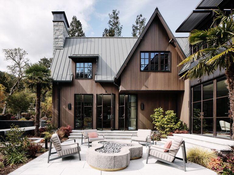 A contemporary house with a large patio area and a fire pit, perfect for entertaining and enjoying outdoor evenings.