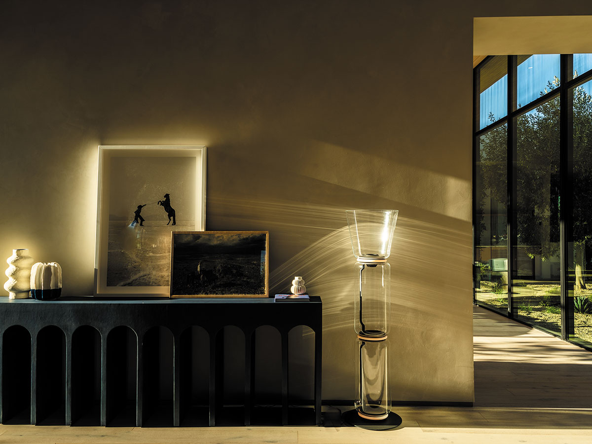 A bright room featuring a large window and a wooden table, creating an inviting atmosphere.