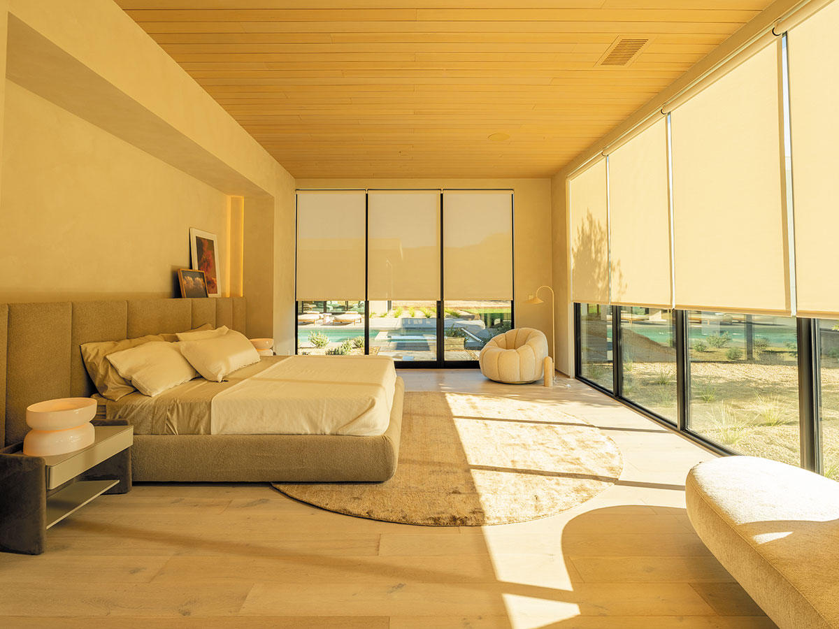 A well-furnished bedroom with a bed and a chair, emphasizing comfort and tranquility.