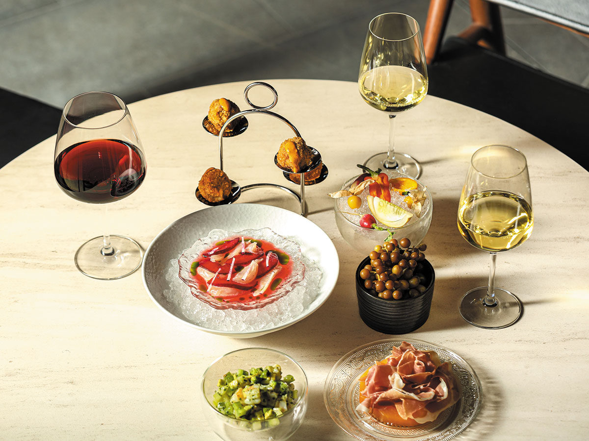 A table set with an assortment of dishes and wine bottles, showcasing a festive dining experience.