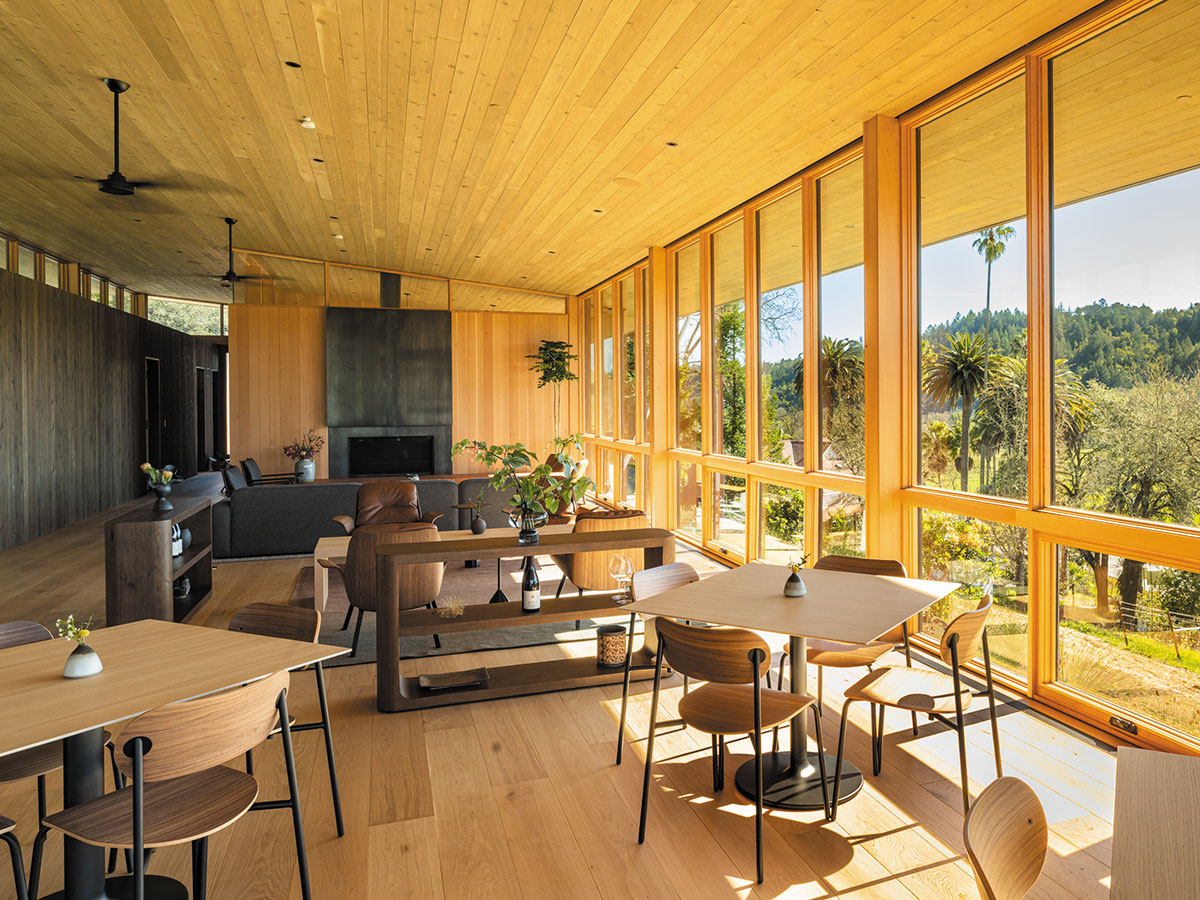 A spacious room featuring a large table surrounded by several chairs.
