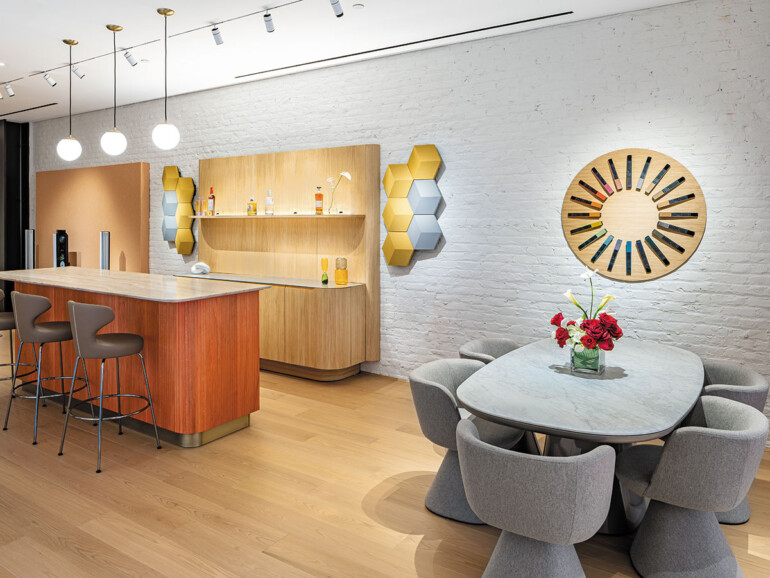 A cozy kitchen scene with a dining table and four chairs, complemented by cabinets and kitchen appliances.