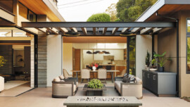 A cozy patio featuring a fire pit surrounded by a comfortable couch for relaxation and social gatherings.