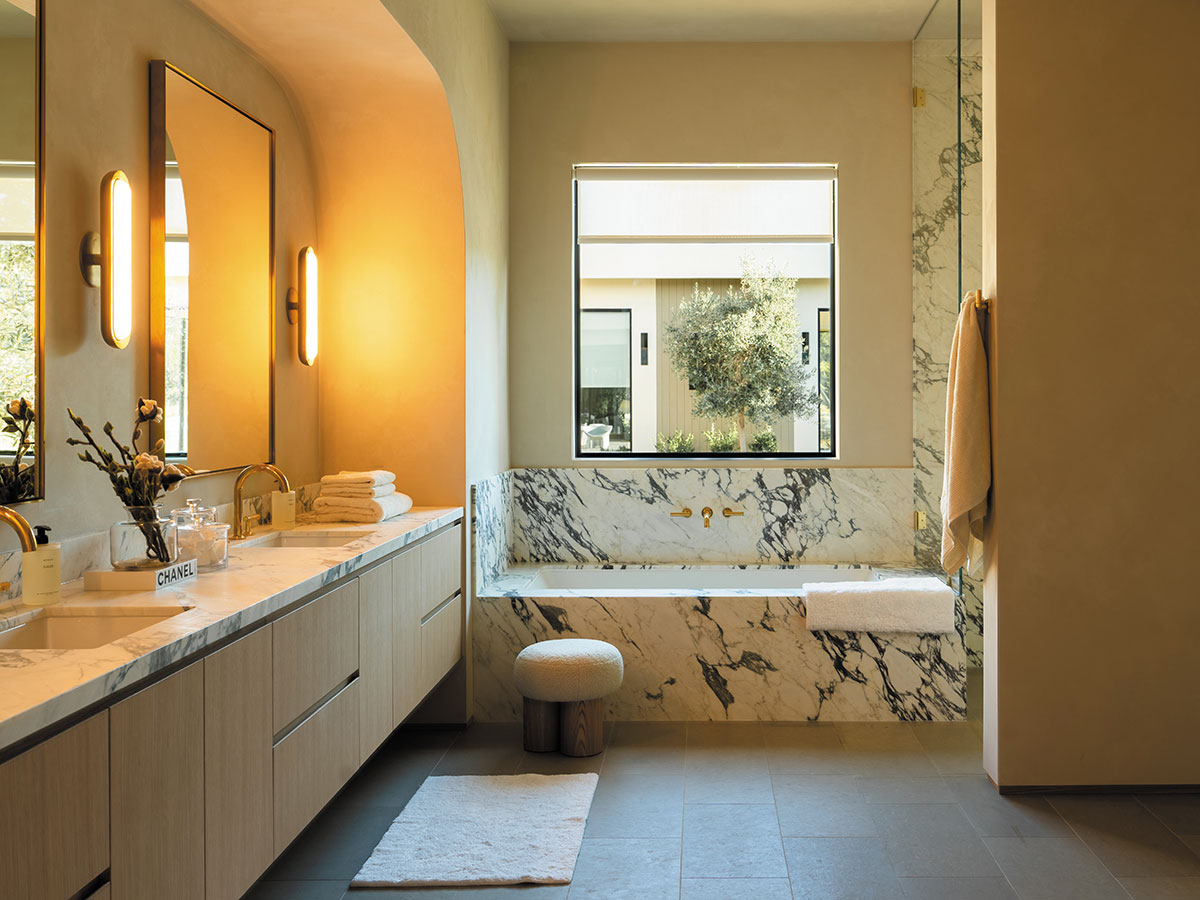Stylish bathroom with a polished marble counter and a comfortable bathtub