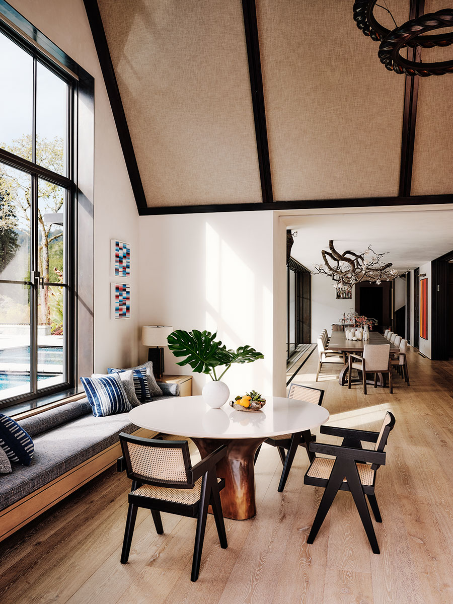 A modern dining room featuring a large table surrounded by stylish chairs, creating an inviting atmosphere for meals.