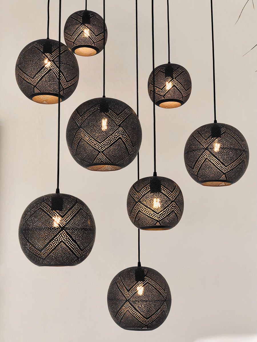 A collection of black and white pendant lights hanging from the ceiling, creating a modern and stylish ambiance.