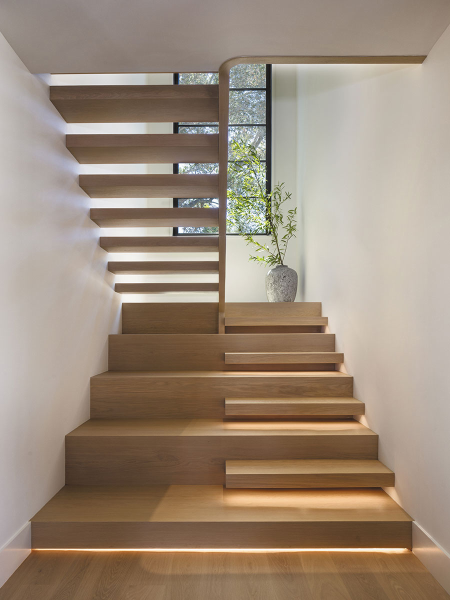 Pistache limestone and bluestone feature prominently in the outdoor scheme, the staircase is at once sculptural and utilitarian