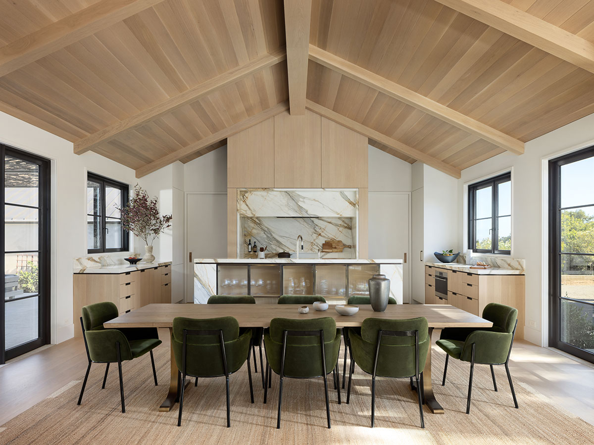 The kitchen features Henrybuilt cabinets, while the dining room is anchored by a Sobu table with a custom finish