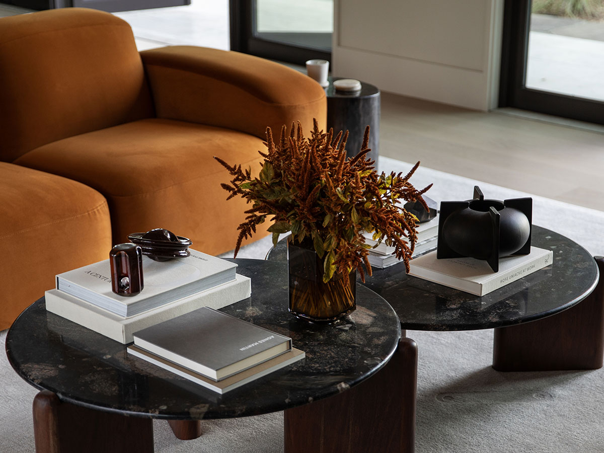The marble-topped coffee tables are from CB2, one of which was modified for a nesting effect