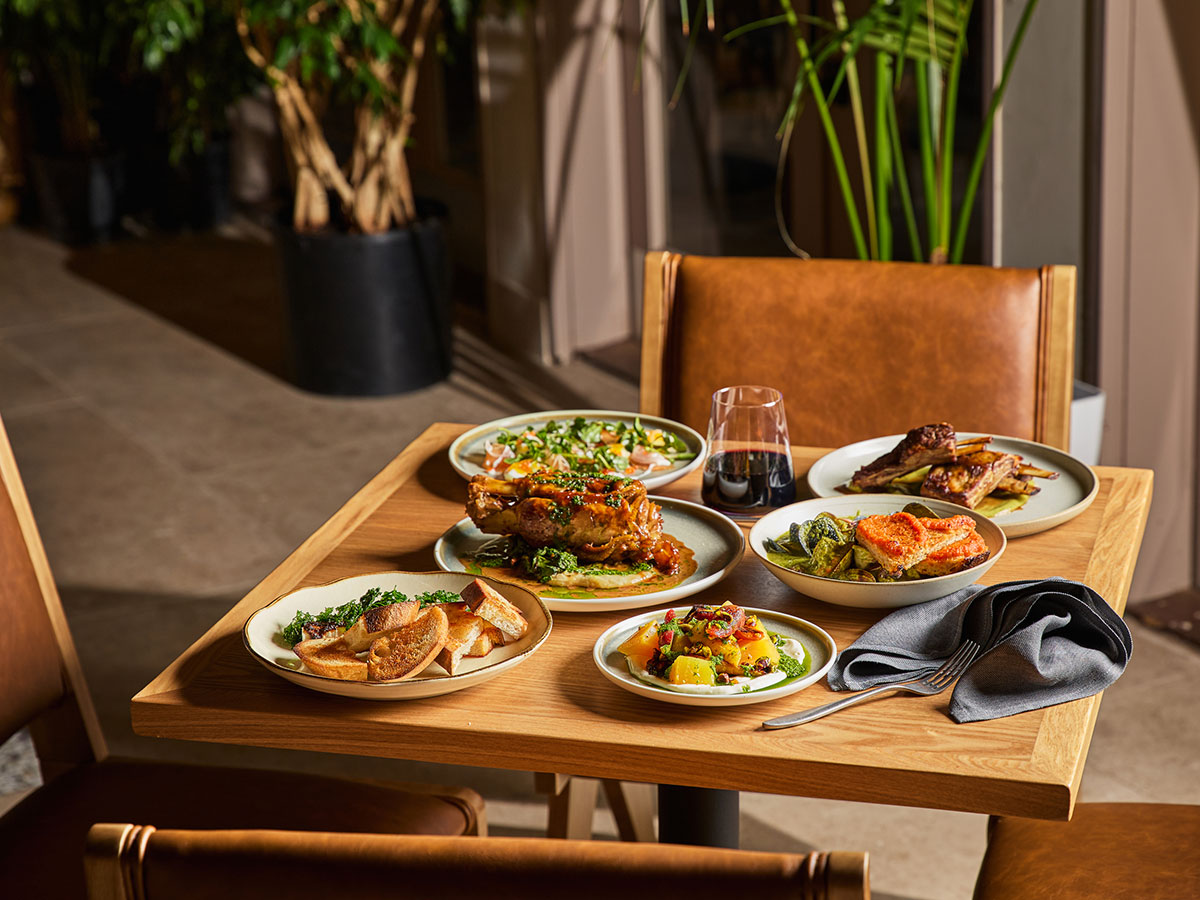 A dining table adorned with an assortment of food items and beverages, ready for a meal.