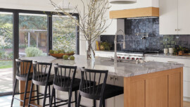 A modern kitchen featuring a spacious island and a stylish bar area for dining and entertaining.