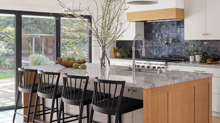 A modern kitchen featuring a spacious island and a stylish bar area for dining and entertaining.