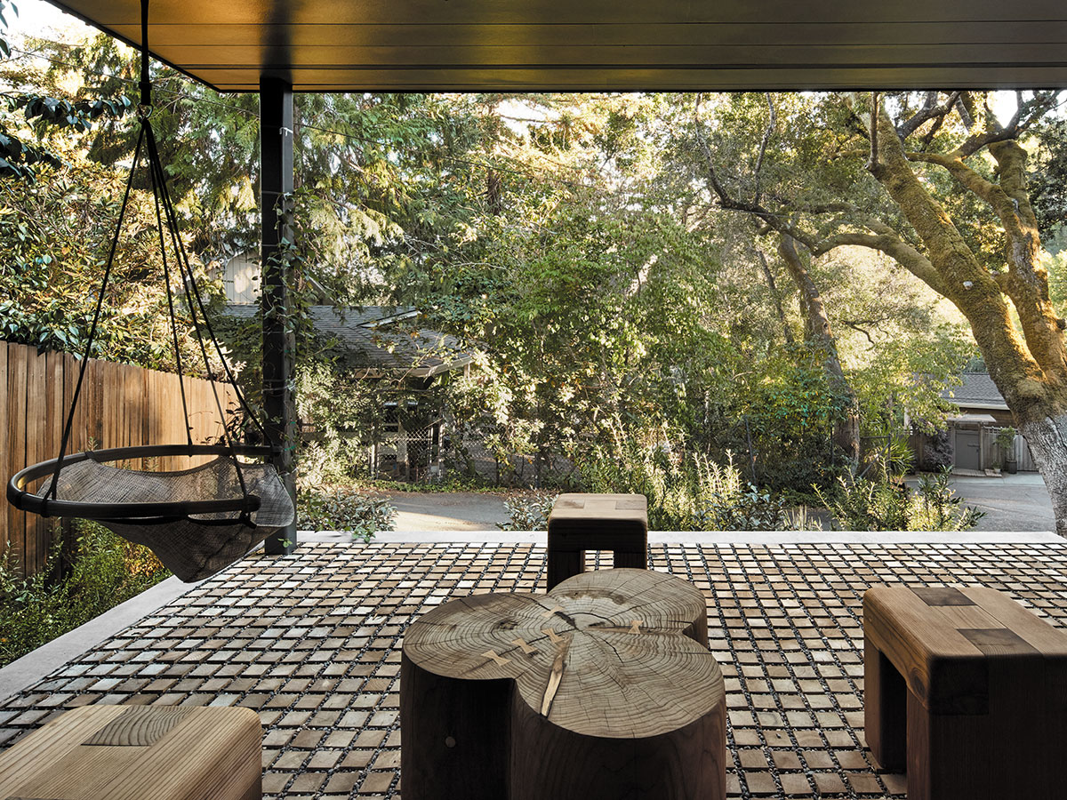 A wooden deck featuring a railing and a bench, set in a serene outdoor environment.