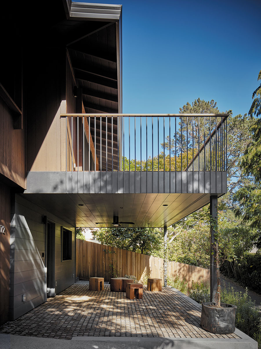 A wooden deck featuring a railing and a bench, set in a serene outdoor environment.